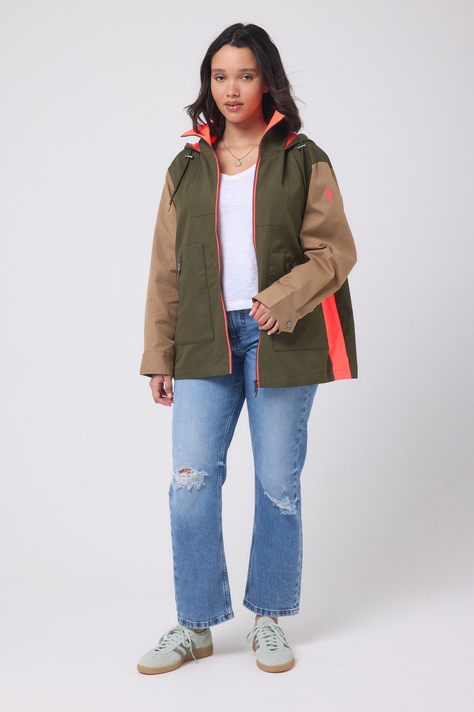 Scamp and Dude Khaki with Camel and Coral Colourblock Short Trench Coat | Model wearing a colourblock short trench coat with distressed jeans and a white v-neck t-shirt.