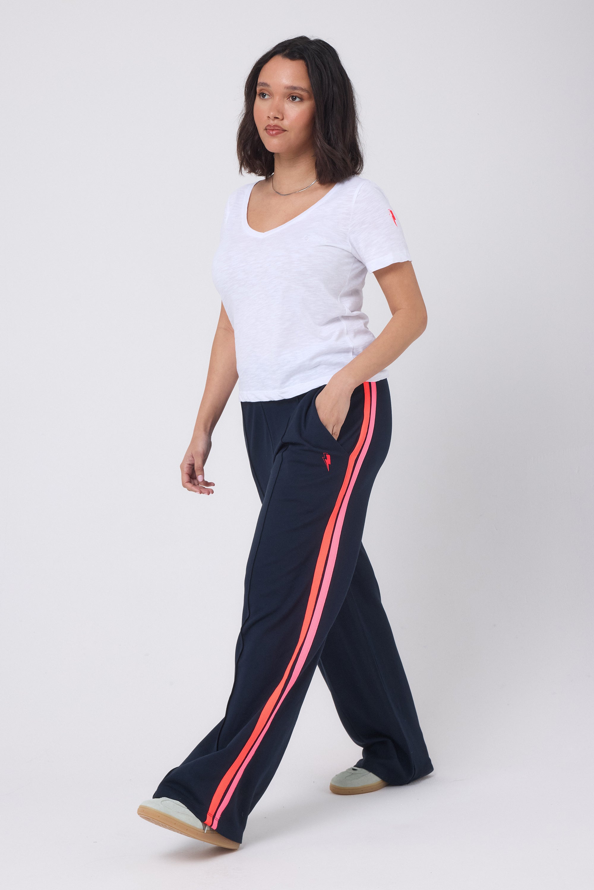 Scamp and Dude Navy Colourblock Wide Leg Jersey Trousers | Model wearing a white v-neck t-shirt with a pair of a navy wide leg trousers.