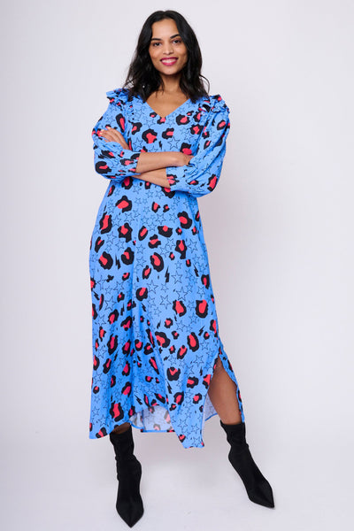 Scamp and Dude Blue with Pink Snow Leopard Star and Lightning Bolt Midi Dress | Model wearing blue leopard and star print maxi dress with back boots on white background