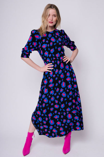 Scamp and Dude Black with Electric Blue and Pink Snow Leopard Midi Dress | Blonde model wearing black, print and blue leopard print long dress with pink boots