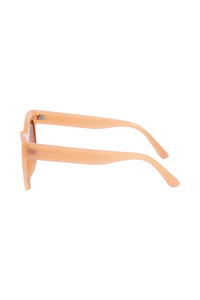 Peach cat eye sunglasses with Scamp & Dude text and lightning bolt logoon the arms in white 