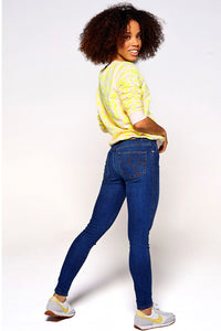 Scamp and Dude Authentic Skinny Jeans Dark Wash | Model with short curly hair wearing skinny dark wash jeans and yellow patterned jumper