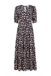 Black v-neck maxi dress with pale peach leopard and lightning bolt print, with short puffed sleeves and a tiered effect skirt