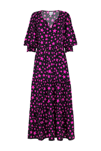 A black maxi dress with magenta star and lightning bolt print, the dress has 3/4 length blouson sleeves, a tiered skirt, a tie  V-neck and a neon pink embroidered lightning bolt on the sleeve