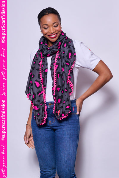 Scamp and Dude Grey and Pink Leopard Print Scarf | Model wearing a white t-shirt with blue jeans with a grey and pink leopard print scarf